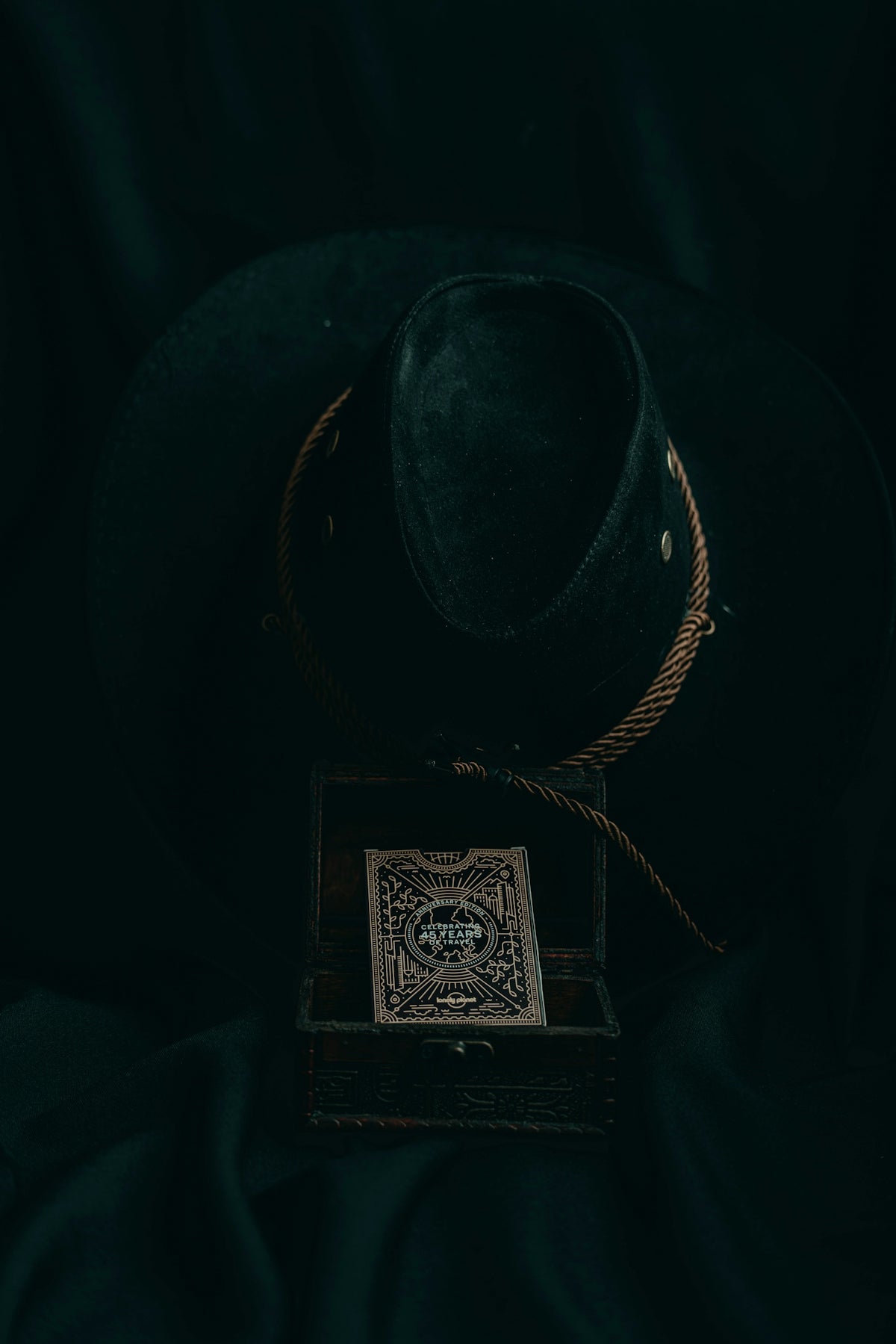 a black hat sitting on top of a wooden box